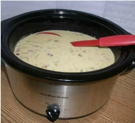 Delicious bowl of crockpot potato soup with ingredients and toppings