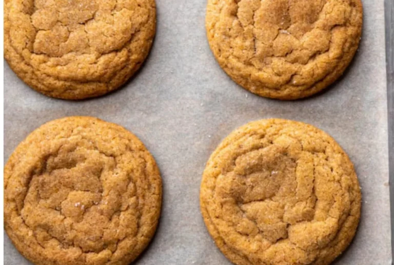 Chewy pumpkin cookies fresh out of the oven with a sprinkle of cinnamon on top