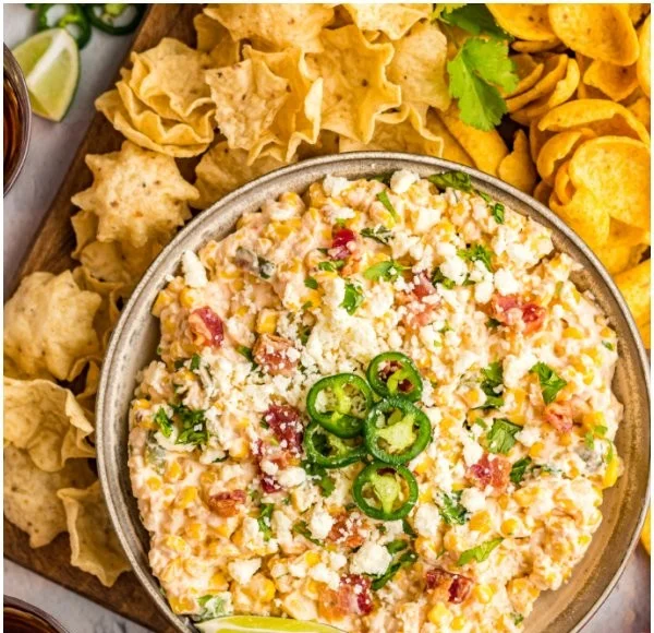 Bowl of creamy Crack Corn Dip served with tortilla chips.