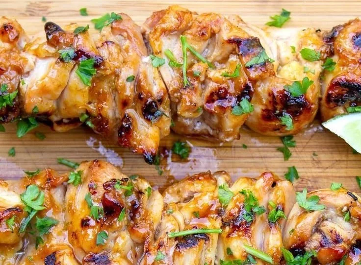 Served plate of honey-lime spicy chicken garnished with lime slices