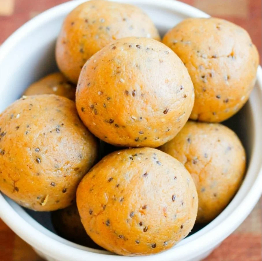 Healthy no-bake pumpkin pie energy balls with ingredients displayed.