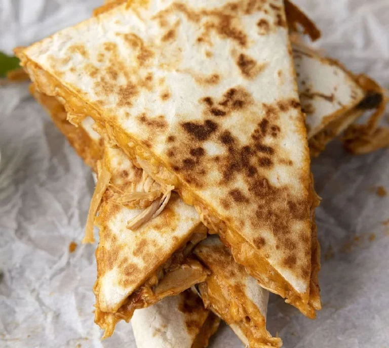 Slow cooker queso chicken quesadillas served on a plate