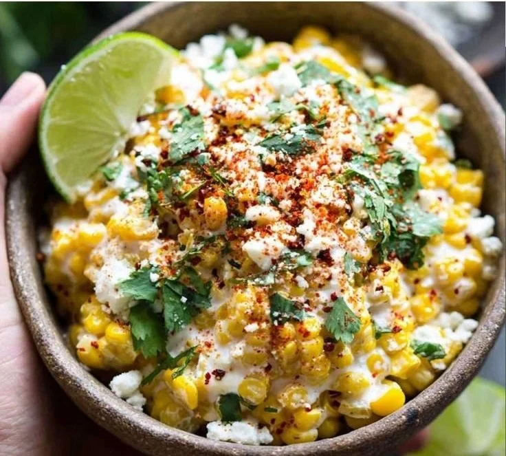 Delicious spicy Mexican street corn served on a wooden platter, garnished with cilantro.