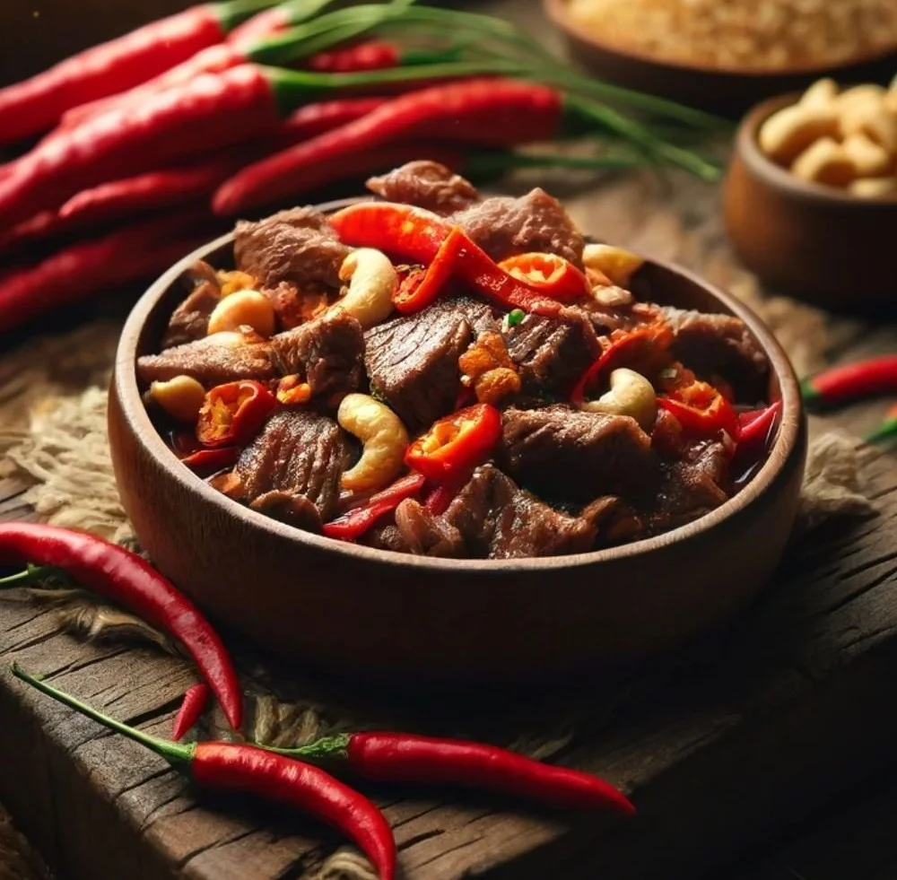 Plate of Thai Beef Chili with Cashew Nuts garnished with fresh herbs