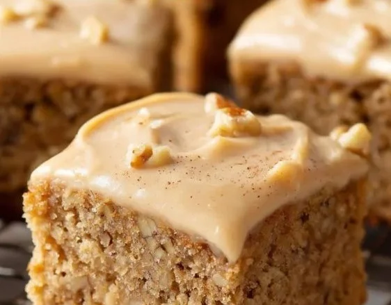 Delicious banana bread brownies topped with chocolate chips on a serving plate.