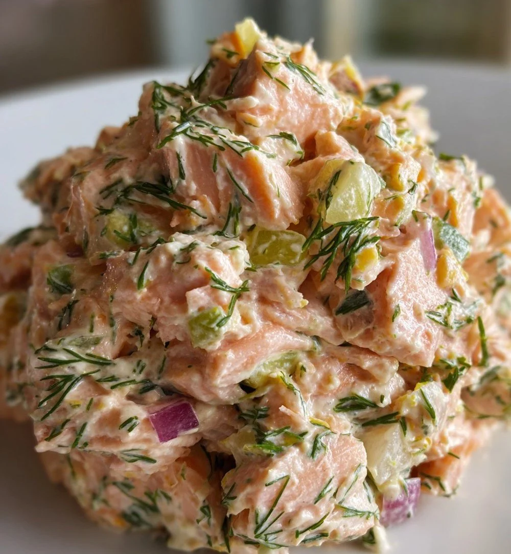 Canned salmon dish garnished with dill and lemon on a plate