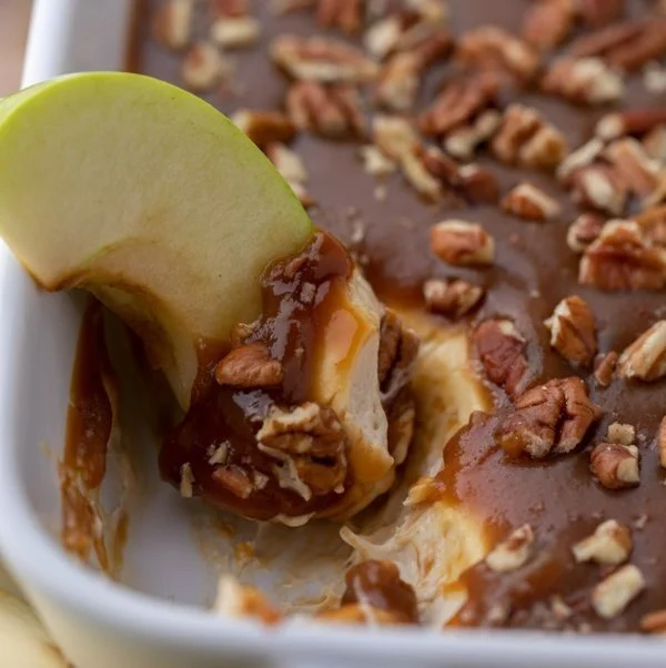 Delicious Caramel Apple Cheesecake Dip served in a bowl with apple slices