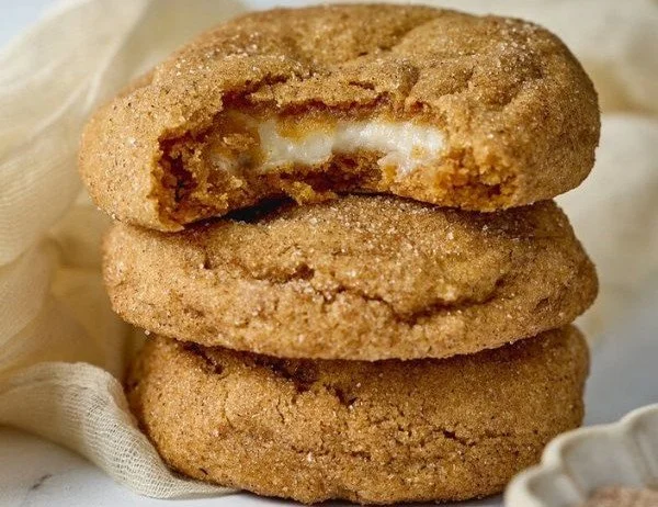 Chewy pumpkin cheesecake cookies freshly baked and served on a plate