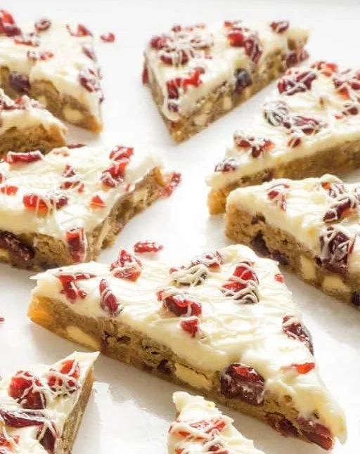 Delicious cranberry bliss bars topped with cream cheese frosting and cranberries