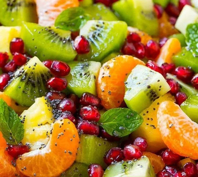 Colorful easy winter fruit salad with seasonal fruits in a bowl