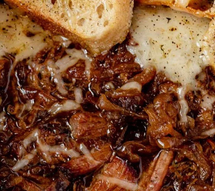 Delicious French Onion Pot Roast served with herbs and onions