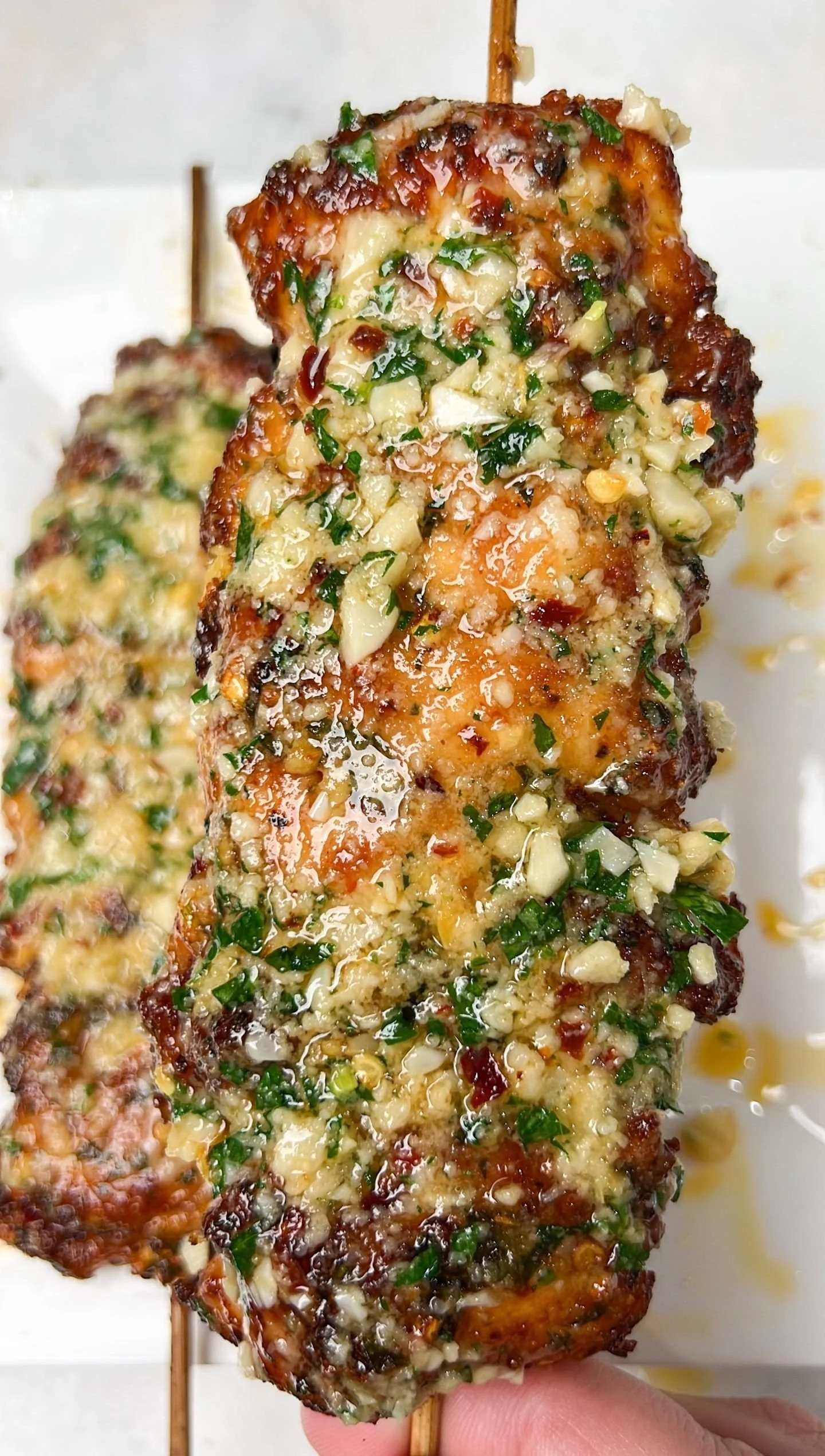 Plate of Garlic Parmesan Chicken Skewers with herbs and spices