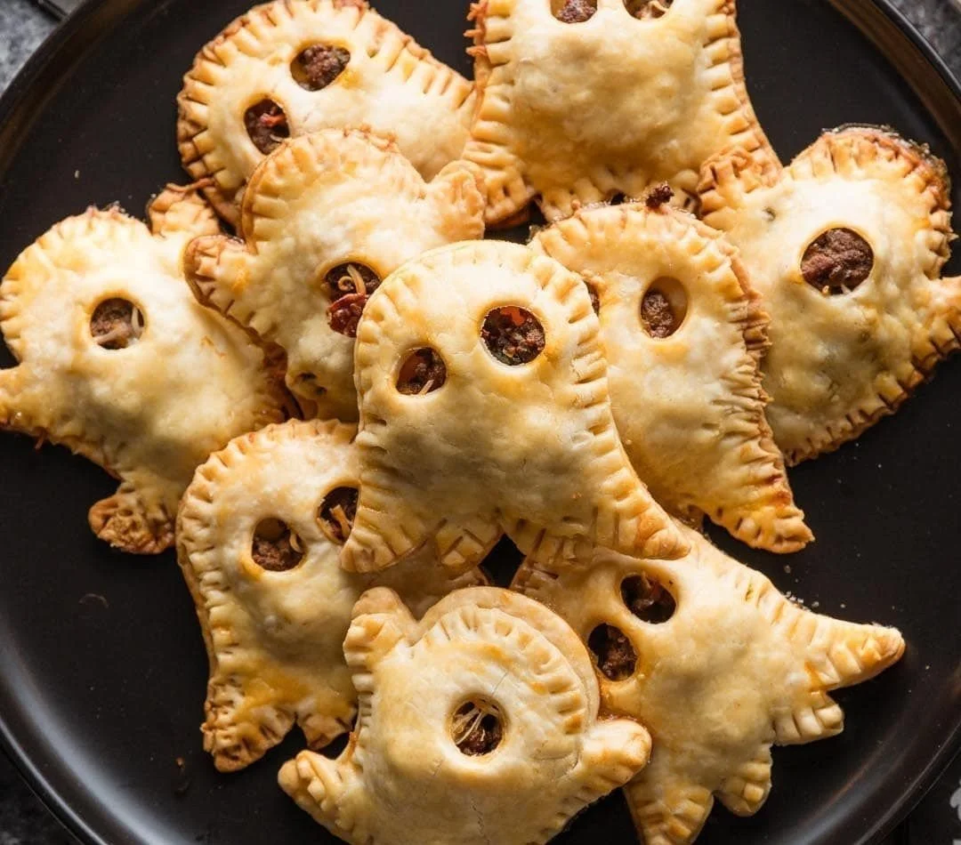 Delicious ghost-inspired mini taco pies served on a festive Halloween plate.