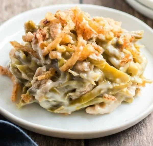 Delicious green bean casserole topped with crispy onions in a baking dish