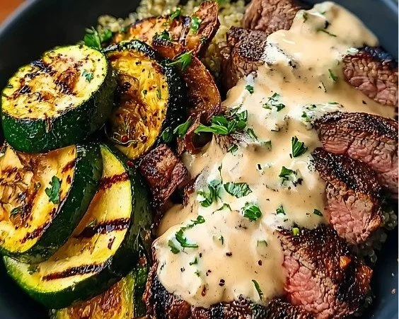 Delicious grilled steak bowl with creamy sauce and grilled zucchini