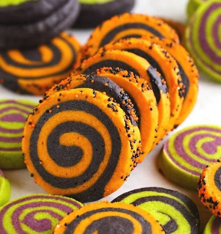 Colorful Halloween pinwheel sugar cookies on a plate