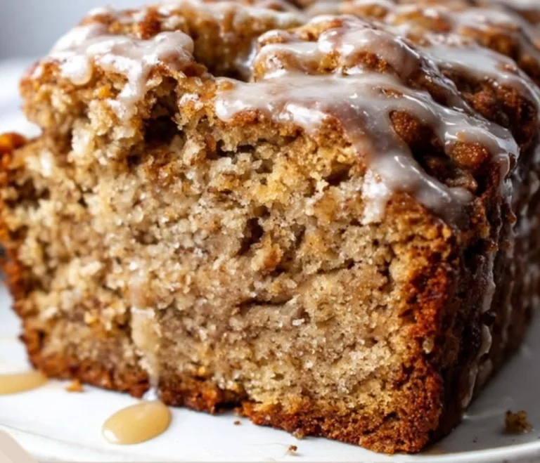 Moist pumpkin banana bread slice on a plate with a fork