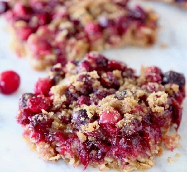 Homemade oatmeal cranberry bars on a wooden table
