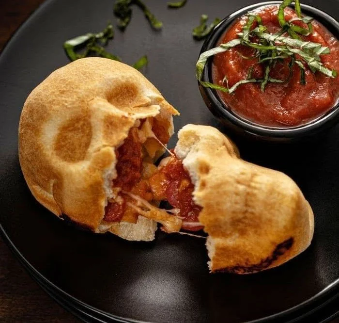 Spooky Halloween pizza skulls with cheese and toppings arranged for Halloween