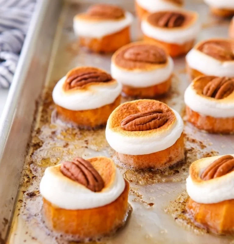 Sweet potato bites topped with marshmallows and pecans, a delightful treat.