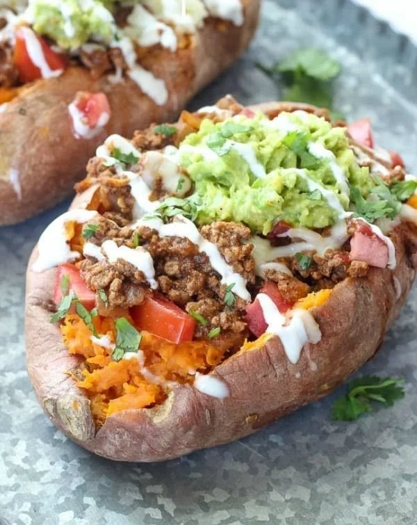 Stuffed sweet potatoes with taco filling on a plate